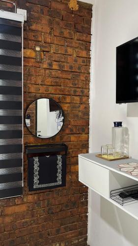 a brick wall with a mirror and a keyboard at Roomstay By Abe Cottage in Kuala Besut