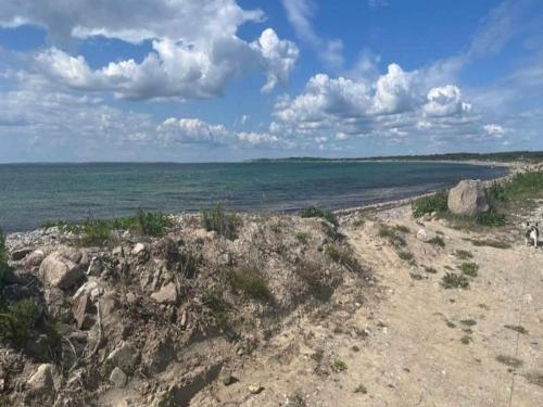 a view of the ocean from a sandy beach at 3 person holiday home in Ærøskøbing in Ærøskøbing