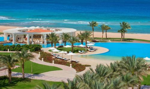 an aerial view of a resort with a pool and the ocean at Baron Palace Sahl Hasheesh in Hurghada