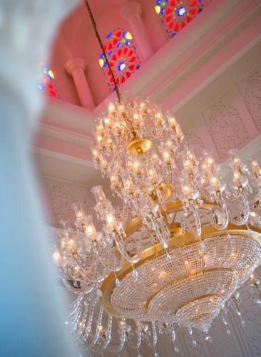 a large chandelier hanging from a ceiling at Baron Palace Sahl Hasheesh in Hurghada