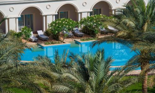 an aerial view of a resort with palm trees at Baron Palace Sahl Hasheesh in Hurghada