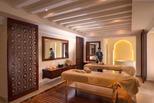a room with two beds and a mirror at Baron Palace Sahl Hasheesh in Hurghada