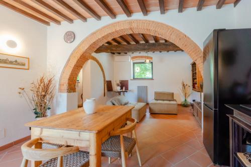 a kitchen and living room with a wooden table at Tenuta Alela in Figline Valdarno