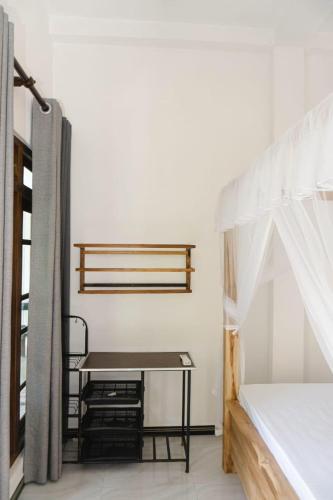 a room with a bed and a table in it at Slip Villa in Ahangama