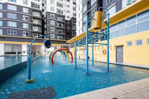 a swimming pool with a water slide in a building at Novo 8 Premier Suites Melaka in Kampong Tambak