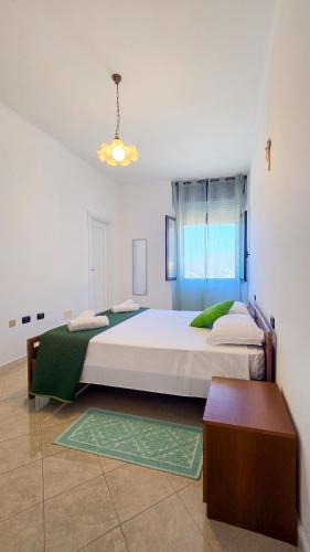 a large bedroom with two beds and a table at Brebei Niedda Hostel in Gonnesa