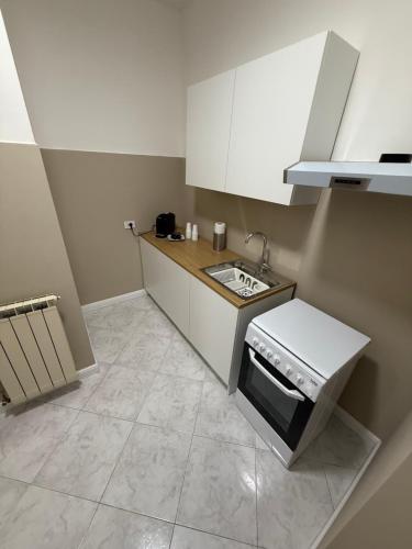 a small kitchen with a sink and a stove at Palazzo SantAntonio Apartament in Naples