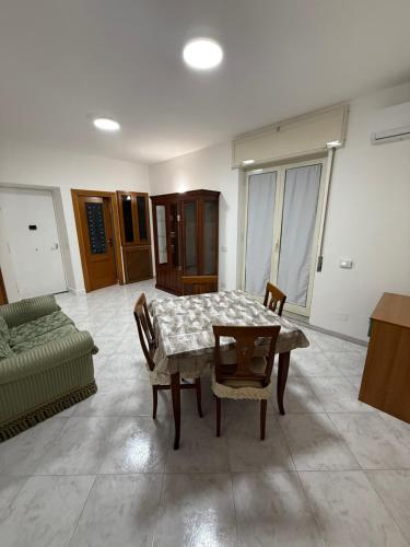a living room with a table and chairs and a couch at Palazzo SantAntonio Apartament in Naples