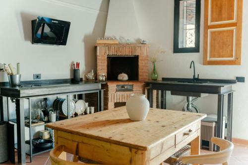 a kitchen with a table with a vase on it at Tenuta Alela in Figline Valdarno