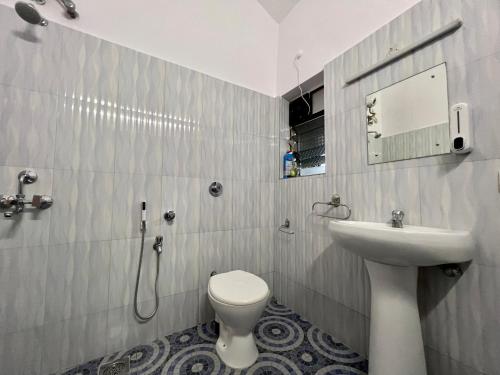 a bathroom with a toilet and a sink at La Bella By The Beach Goa in Goa