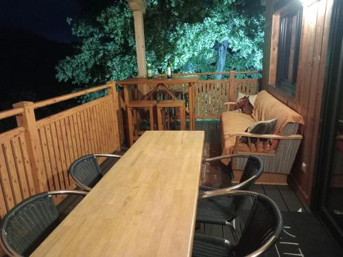 a wooden table and chairs on a deck at Alm-Chalet in der Nähe vom Klippitztörl 