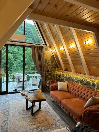 a living room with a couch and a table at Ruby Rize Bungalov in Pazar