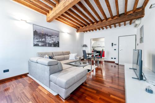 a living room with a couch and a table at Medieval Suite in Piazza Trento-Trieste Ferrara in Ferrara