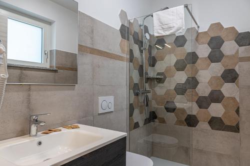 a bathroom with a sink and a shower at Residence Mirage in Caselle Torinese