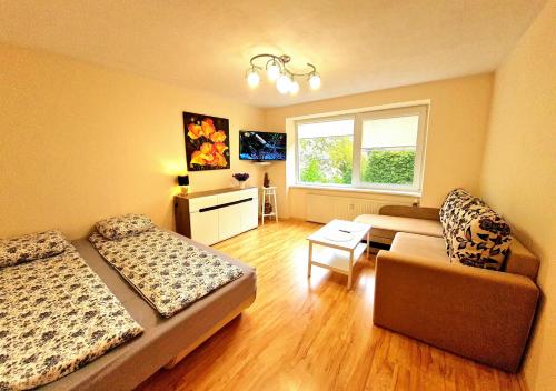 a living room with two beds and a couch at Nida Amber in Nida