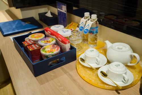 a table with a tray of food and bottles of water at Sandals Mimosa in Da Lat