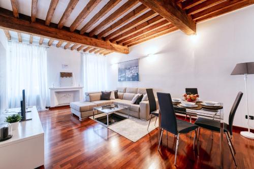 a living room with a couch and a table at Medieval Suite in Piazza Trento-Trieste Ferrara in Ferrara