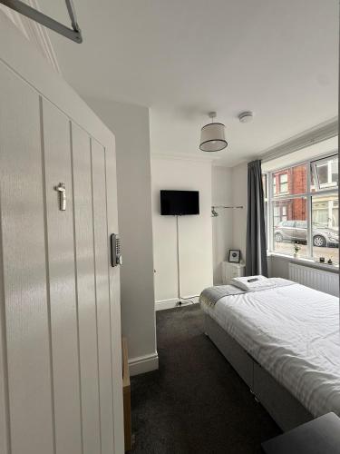 a bedroom with a bed and a window at Charles Street House in Redcar