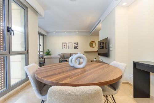 a dining room with a wooden table and chairs at Solidere Lavish Apartments in Downtown Beirut in Beirut