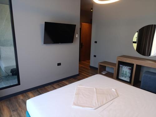 a room with a bed and a tv on a wall at Toka Hotel Restaurant in Pogradec