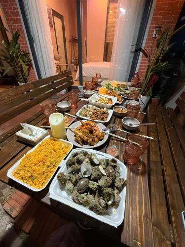 a table with many different dishes of food on it at Hoàng Gia Villa in Phan Rang