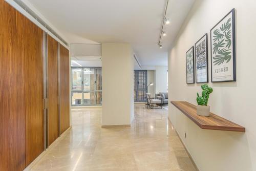 a hallway with a wooden partition and a potted plant at Solidere Lavish Apartments in Downtown Beirut in Beirut