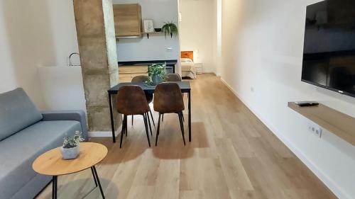 a living room with a couch and a table and chairs at LUXURY APARTMENT SCIENCES CITY Valencia B in Valencia