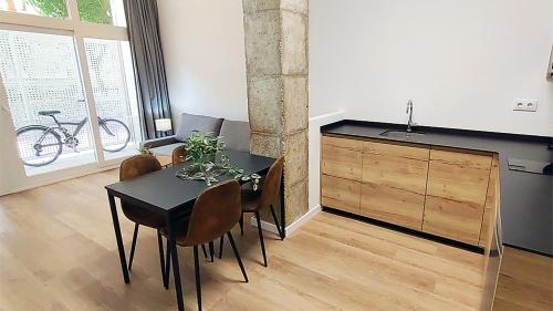 a dining room with a black table and chairs at LUXURY APARTMENT SCIENCES CITY Valencia B in Valencia
