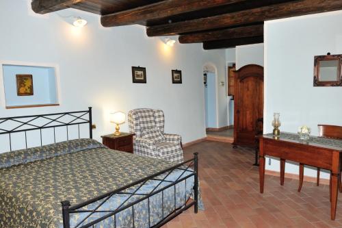 a bedroom with a bed and a desk and a chair at Country House Federico I in Sassoferrato