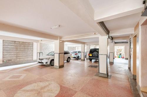 a garage with two cars parked in it at NOVA Stays, Luxe 1BR apartment, South B in Nairobi