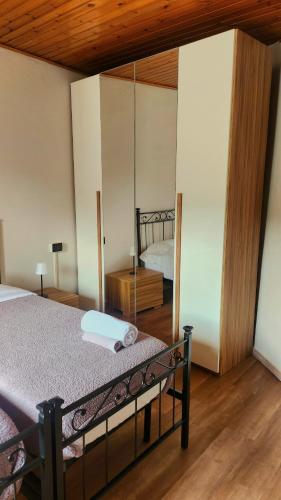 a bedroom with a bed with a mirror in it at La Torretta in Lanzo dʼIntelvi