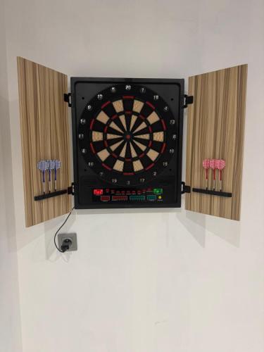 a dart board on a wall with darts at Villa - Détente & Jacuzzi aux portes de Gérardmer in Anould