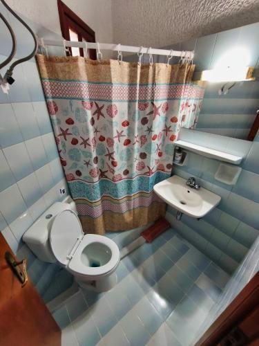 a small bathroom with a toilet and a sink at Akrata Golden Beach House 2 in Aíyira