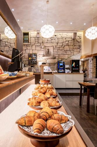 a buffet with several plates of pastries on a table at La Grotta Hotel in San Marino