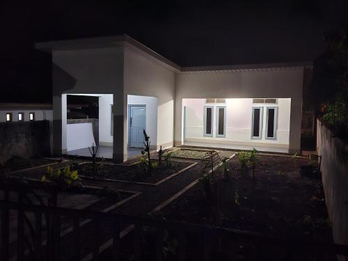 a small house at night with the lights on at De PO'ONG in Ruteng