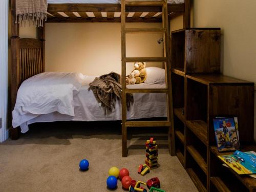 a bedroom with a bunk bed with toys on the floor at Schoone Oordt Country House in Swellendam