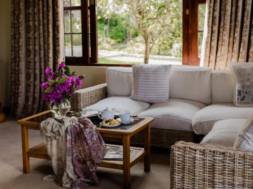 a living room with a couch and a table at Schoone Oordt Country House in Swellendam
