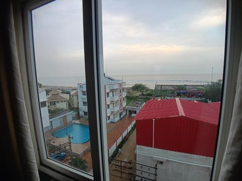 a view of the ocean from a window at Elegant Beach Resort in Mandarmoni