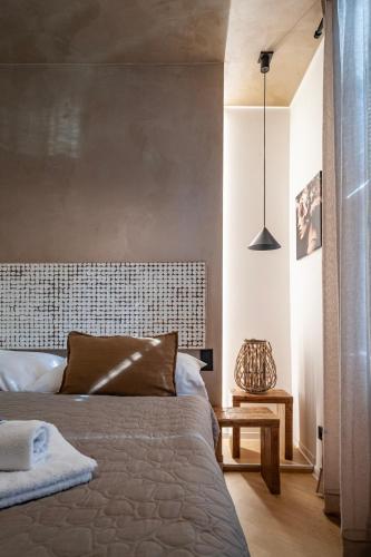 a bedroom with a bed and a pendant light at STING Boutique Apartments in Ostrava