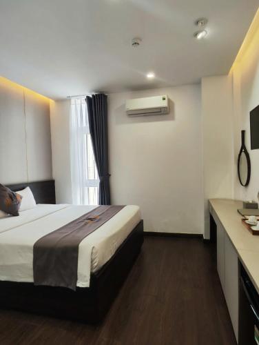 a hotel room with a bed and a window at Nile Hotel Phu Yen in Tuy Hoa