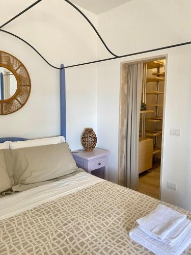 a bedroom with a bed and a mirror at Il Belvedere di Babbo in Fasano