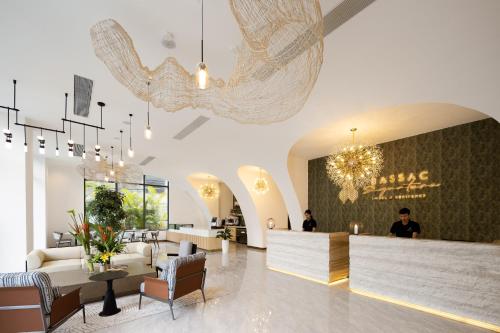 a lobby with a waiting area with a chandelier at Bassac Signature Hotel & Residence in Phnom Penh