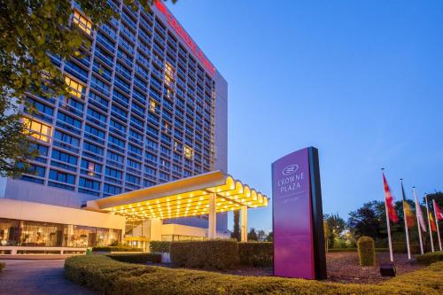 a hotel with a sign in front of a building at Crowne Plaza Antwerpen by IHG in Antwerp