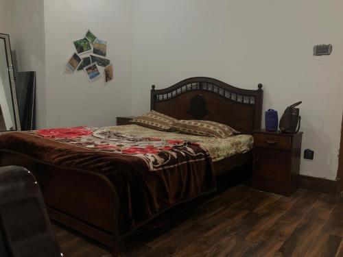 a bedroom with a bed and a wooden floor at Beautiful Place in City centre in Abbottabad