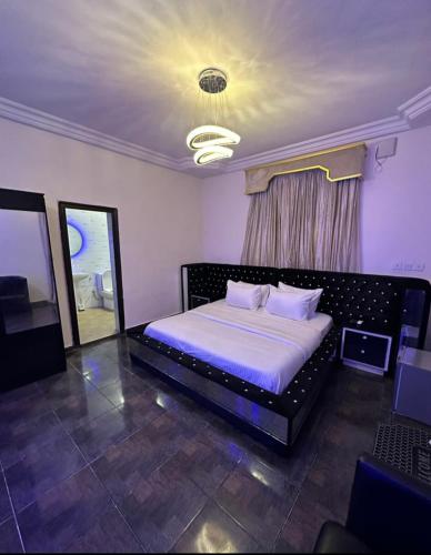 a bedroom with a bed in a room with a mirror at Kf Apartments, Swimming pool, Gym, Wifi in Gwarinpa
