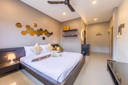 a bedroom with a large bed with white sheets at Infinity Guesthouse in Ko Tao