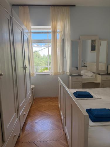 a bedroom with two beds and a large window at Hostel Guesthouse Mira in Omiš