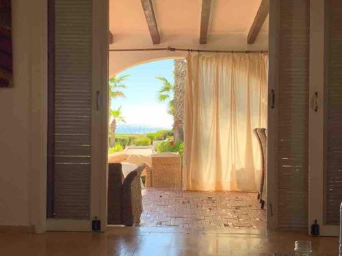 a living room with a large window with a view at Seaside Luxury Villa 4BR - Fnideq - Bahia Smir in Fnidek