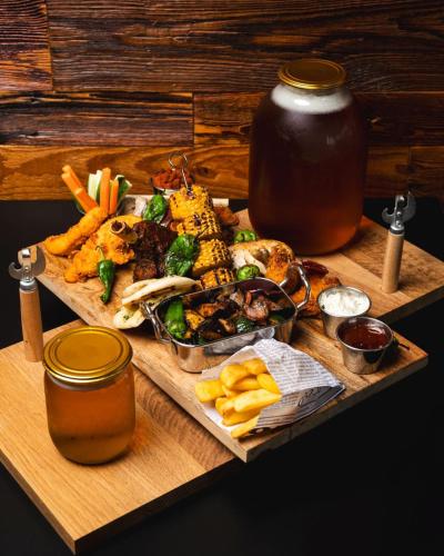 a tray of food on a wooden table with food at Aparthotel Koroni Home in Raszyn