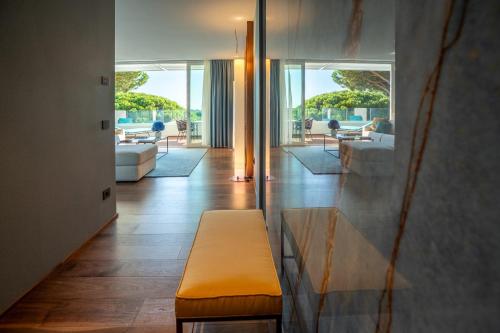 a living room with a couch and a bench at Gallia Palace Hotel - Relais & Châteaux in Punta Ala